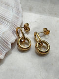 Modern gold link drop earrings with a bold double-loop design. 18k gold plated,
hypoallergenic, and tarnish-resistant.