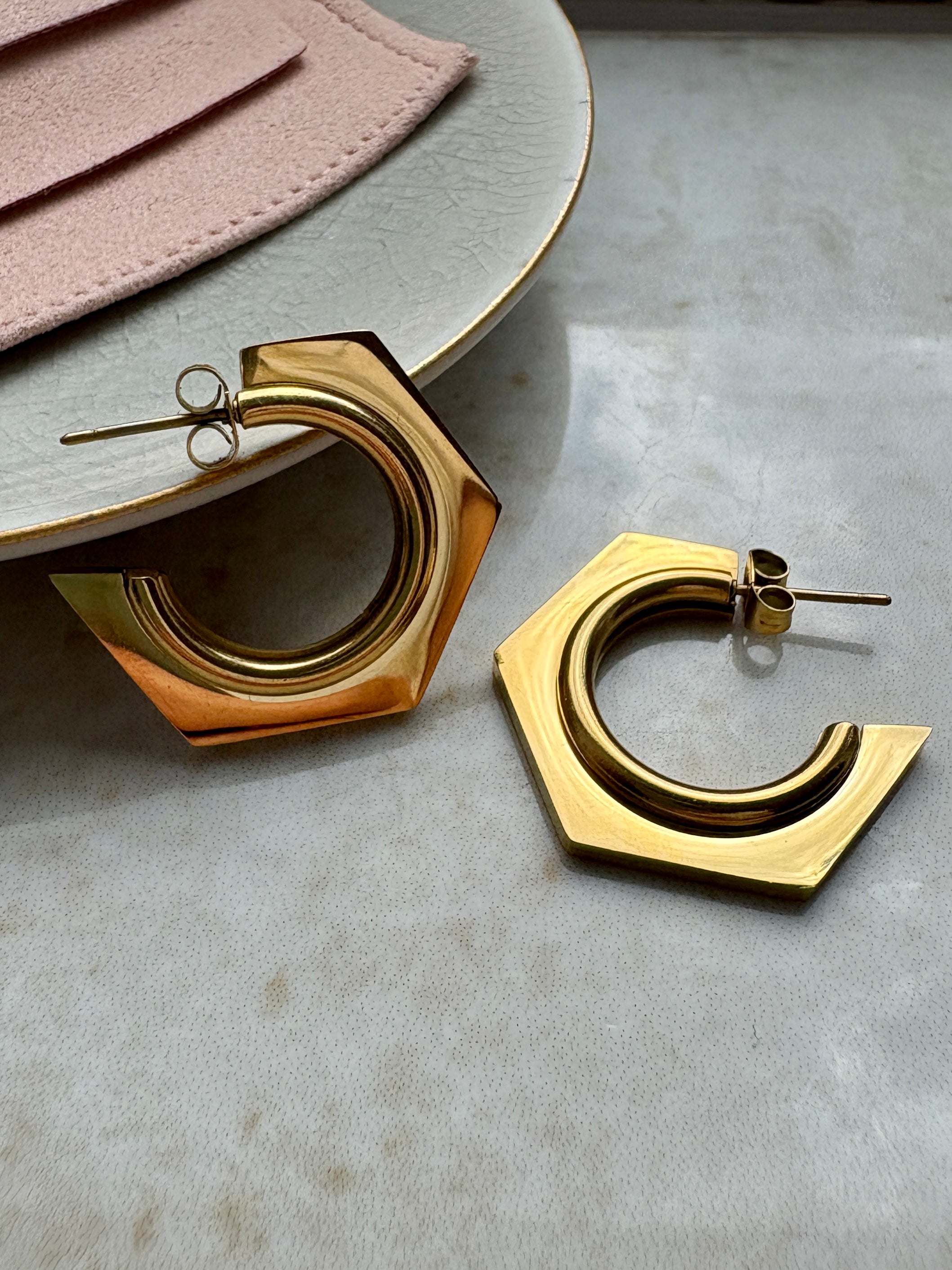 Sleek hexagon gold hoop earrings with a modern geometric design. Lightweight, stylish, and perfect for everyday wear or special occasions.
