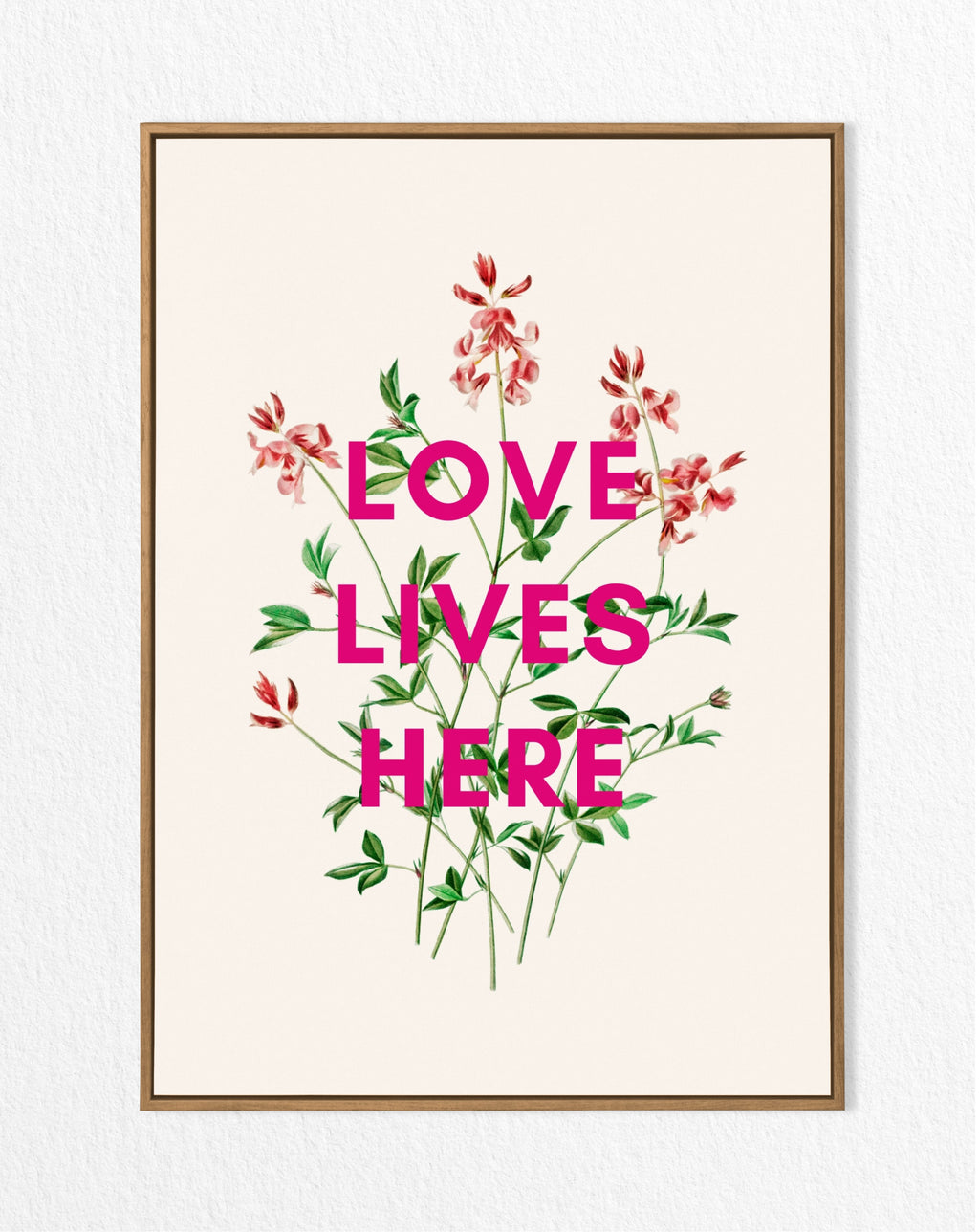 A framed art print with a vintage floral design and the text 'LOVE LIVES HERE' in bold letters.
