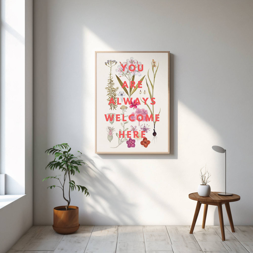 Framed artwork with motivational quote in a bright room with plants and a small table.