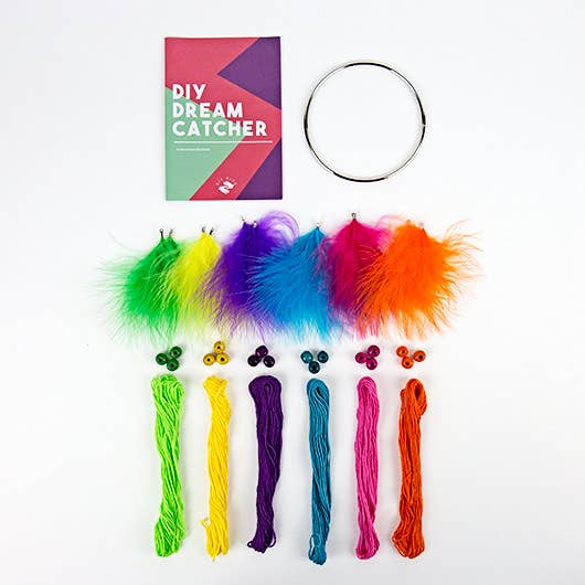 Colorful DIY dream catcher kit with feathers, yarn, and a hoop on a white background.